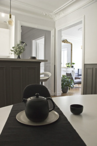 light-filled equipped kitchen black white grey furnished rental in Paris