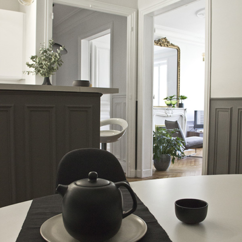 light-filled equipped kitchen black white grey furnished rental in Paris