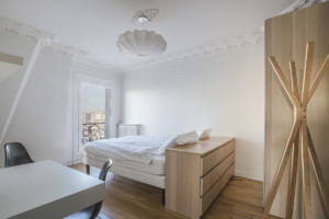 guest bedroom double bed parquet flooring Paris rental