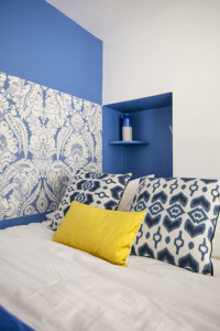 furnished studio sleeping area blue wallpaper