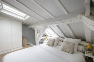 furnished Paris apartment wooden beams painted white