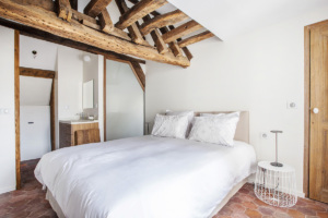 furnished apartment bedroom exposed beams Paris
