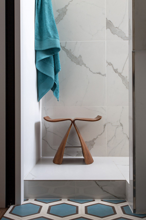 A little wooden stool in the renovated bathroom