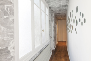 Long corridor in a furnished Haussmanian apartment