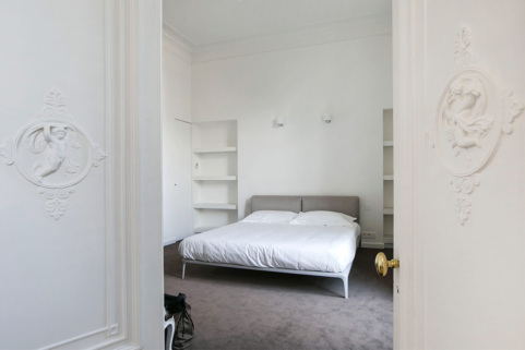 Spacious bedroom in a Haussmannian-style apartment